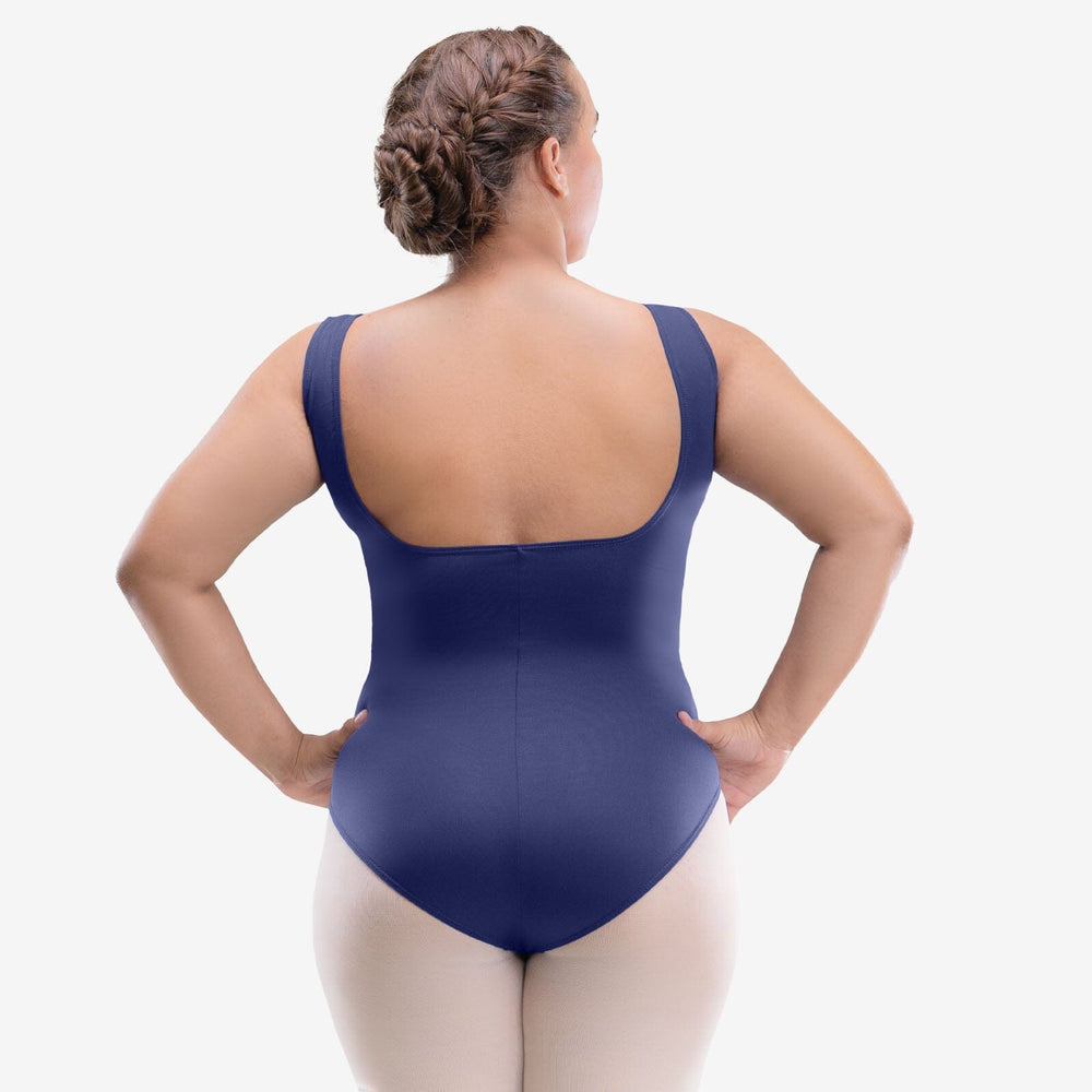 Person wearing a navy blue swimsuit against a white background