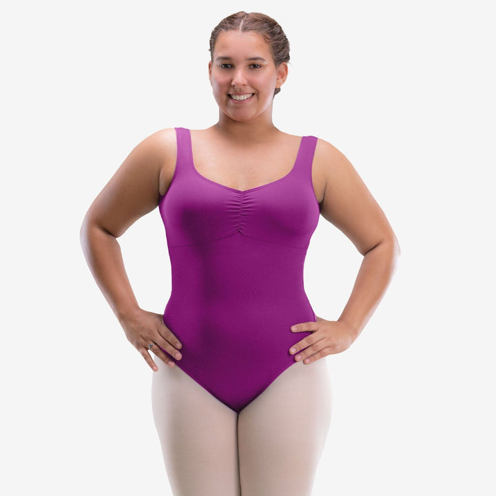 Woman wearing a purple leotard on a white background