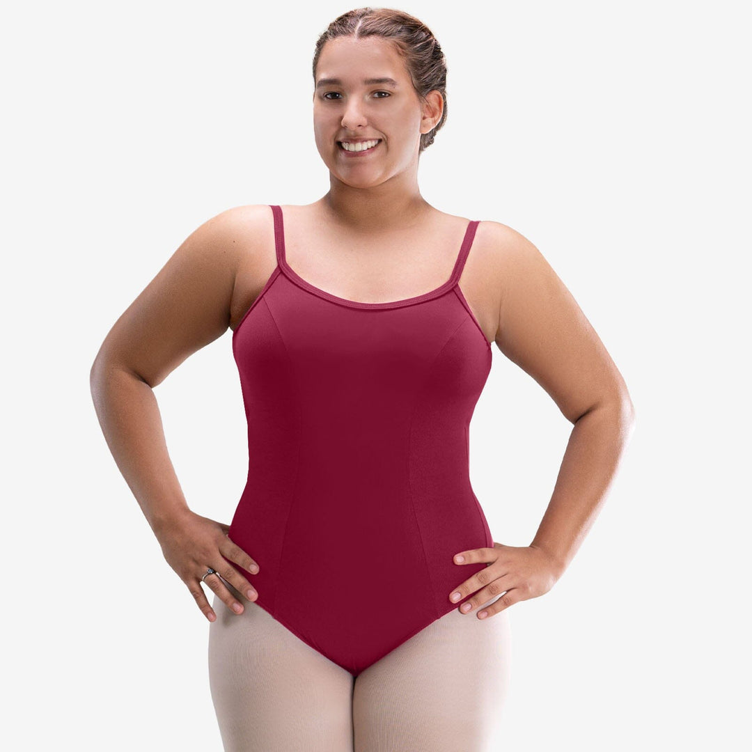Woman wearing a maroon swimsuit against a white background