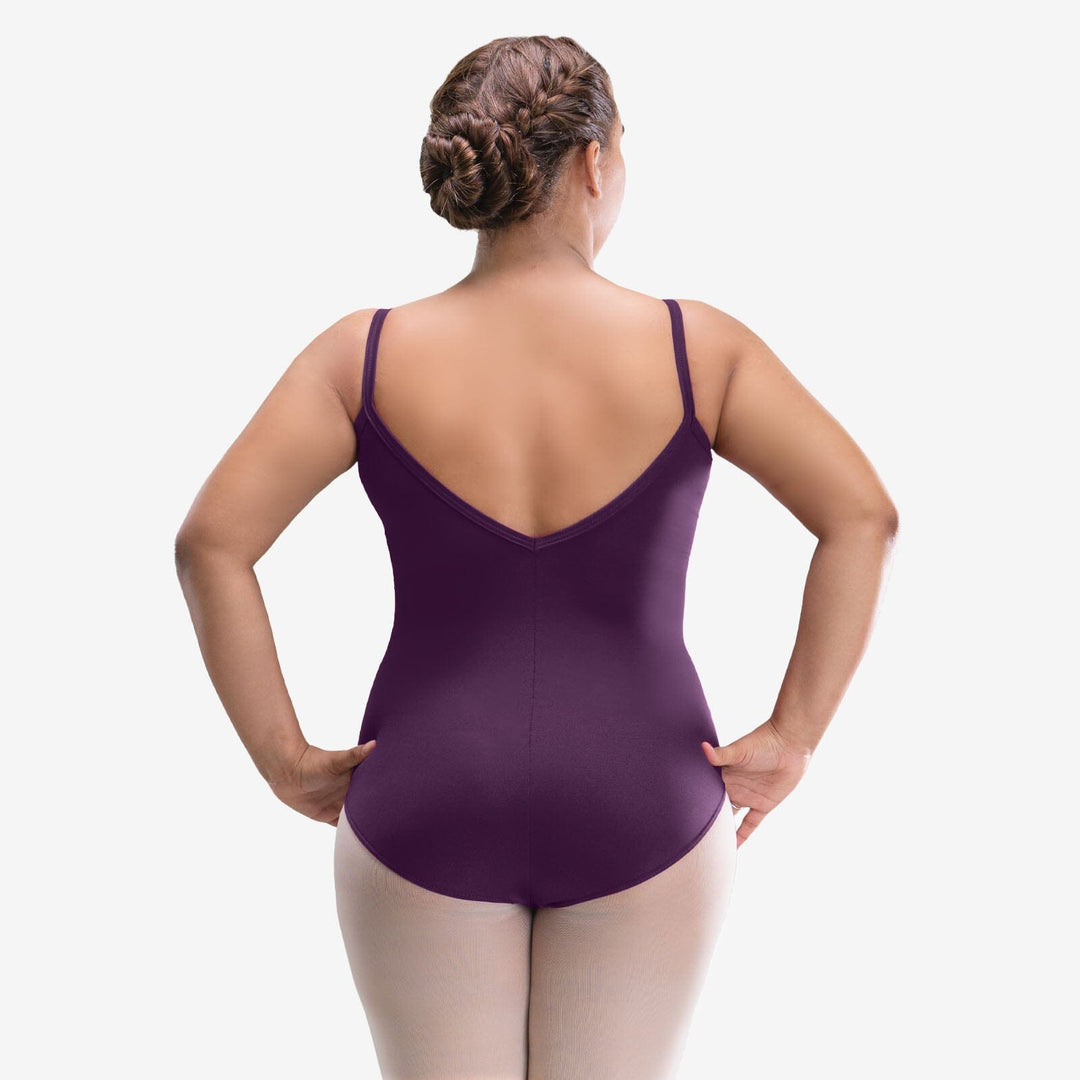 Woman wearing a purple leotard on a white background