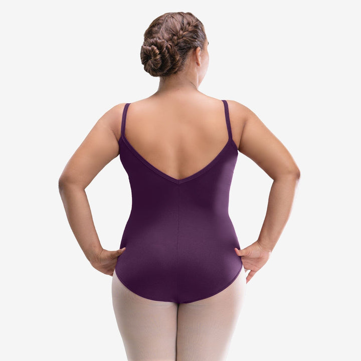Woman wearing a purple leotard on a white background