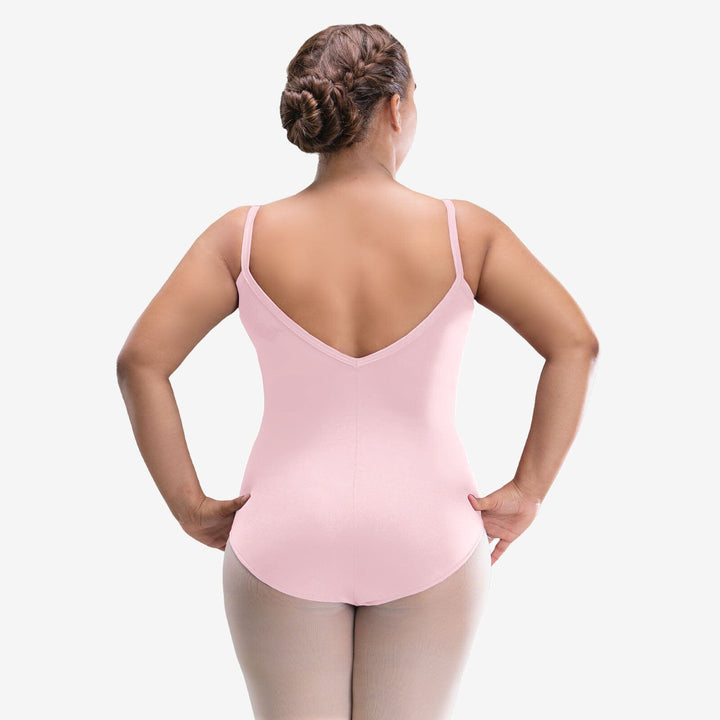 Woman wearing a pink leotard on a white background