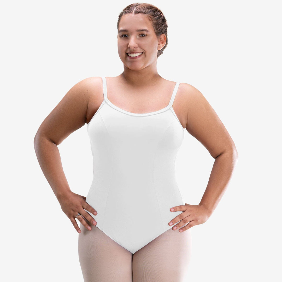 Woman wearing a white bodysuit against a plain background