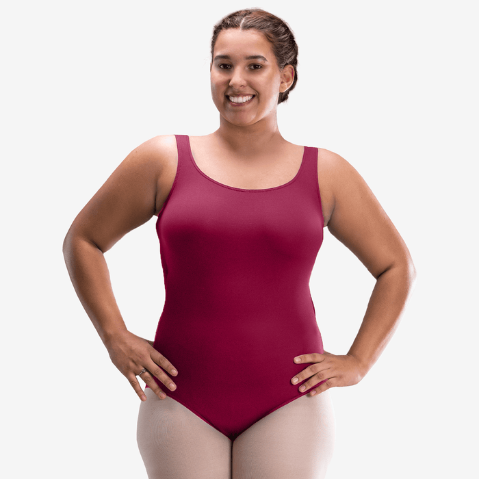 Woman wearing a maroon swimsuit against a white background