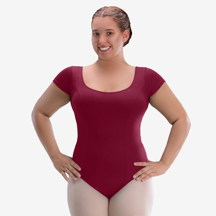 Woman wearing a maroon leotard on a white background