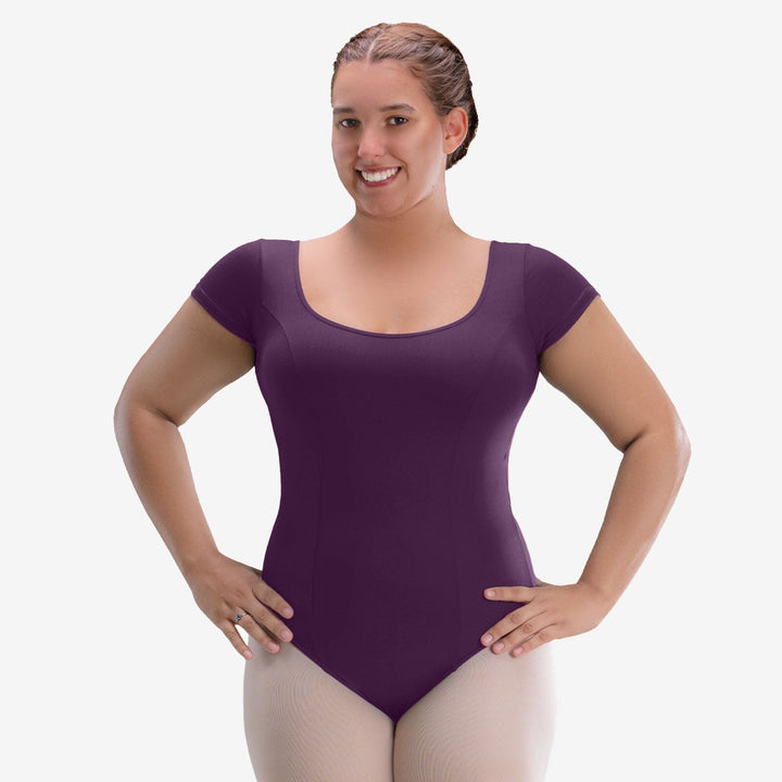 Woman wearing a purple leotard on a white background