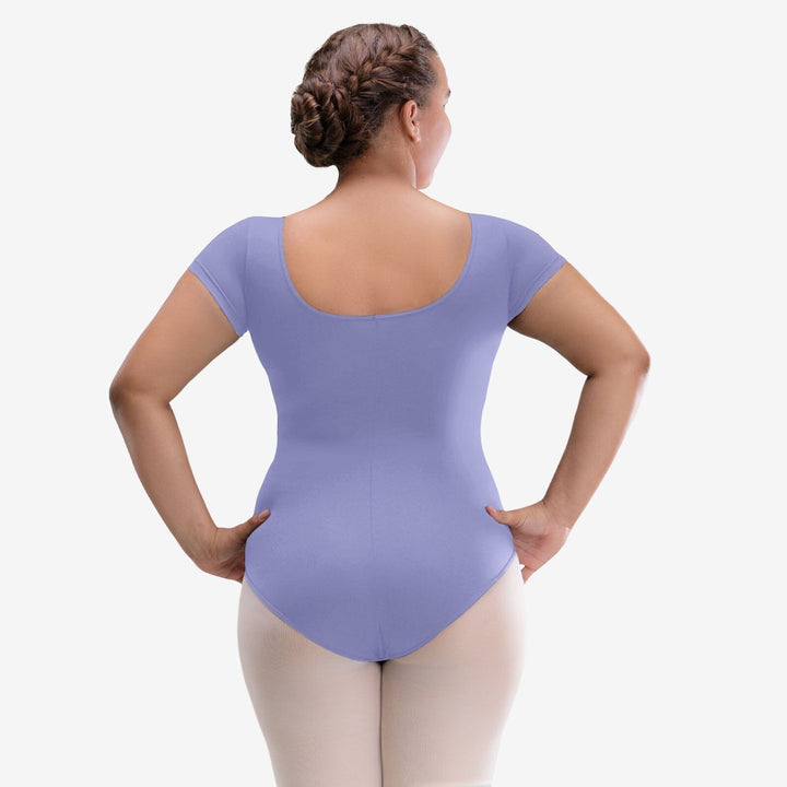 Person wearing a purple leotard on a white background