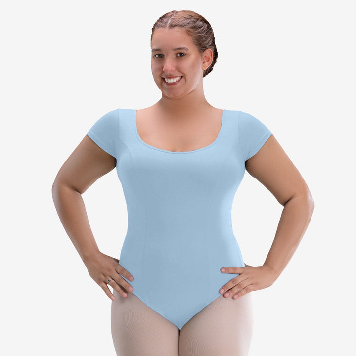 Woman wearing a light blue leotard on a white background