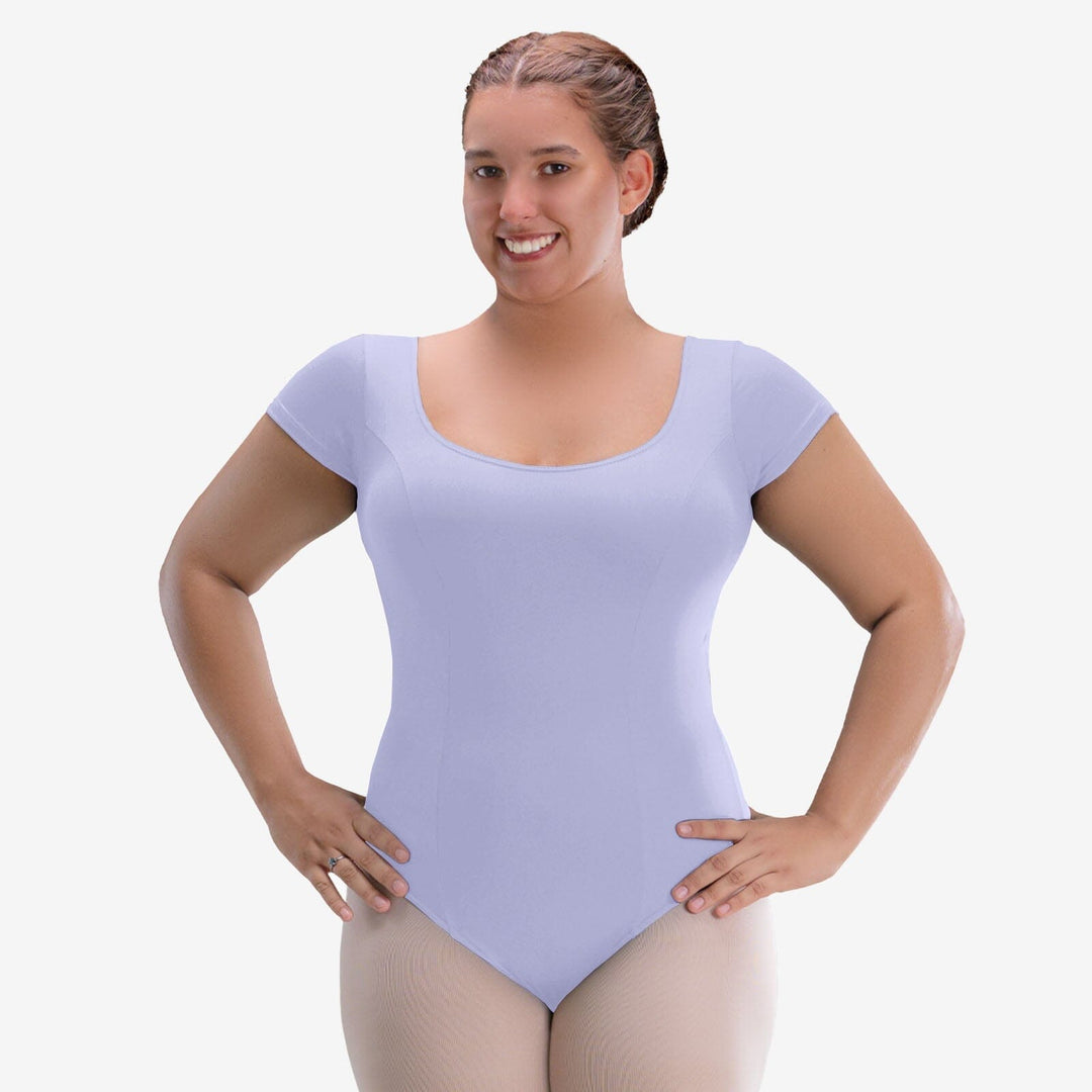 Woman wearing a light purple leotard on a white background