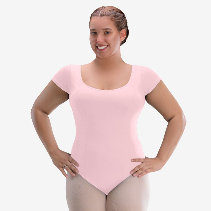 Woman wearing a pink leotard on a white background