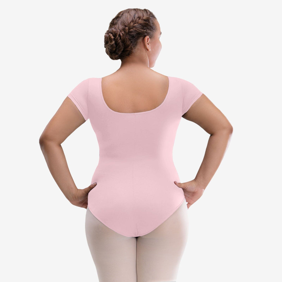 Person wearing a pink leotard on a white background