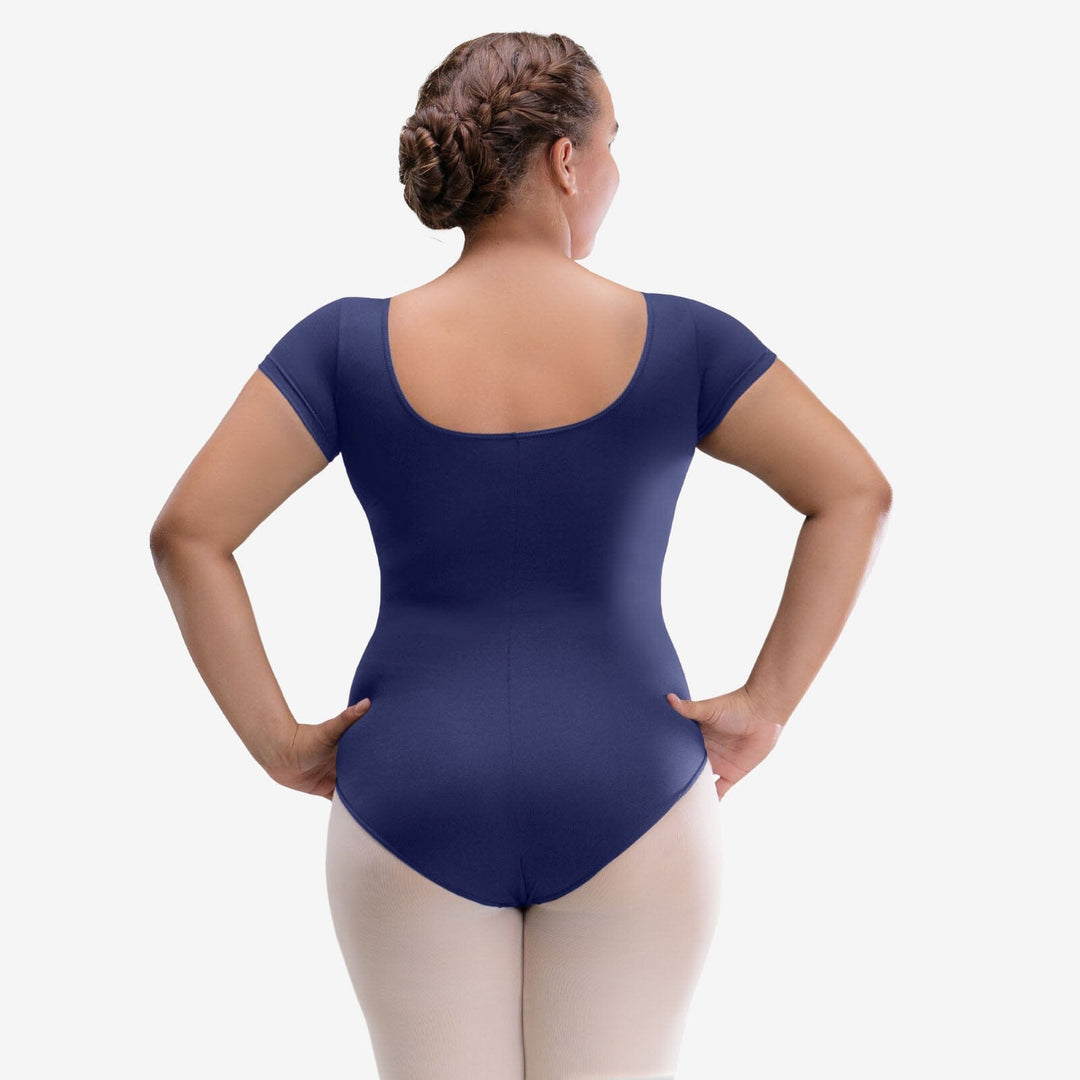 Person wearing a navy blue leotard on a white background