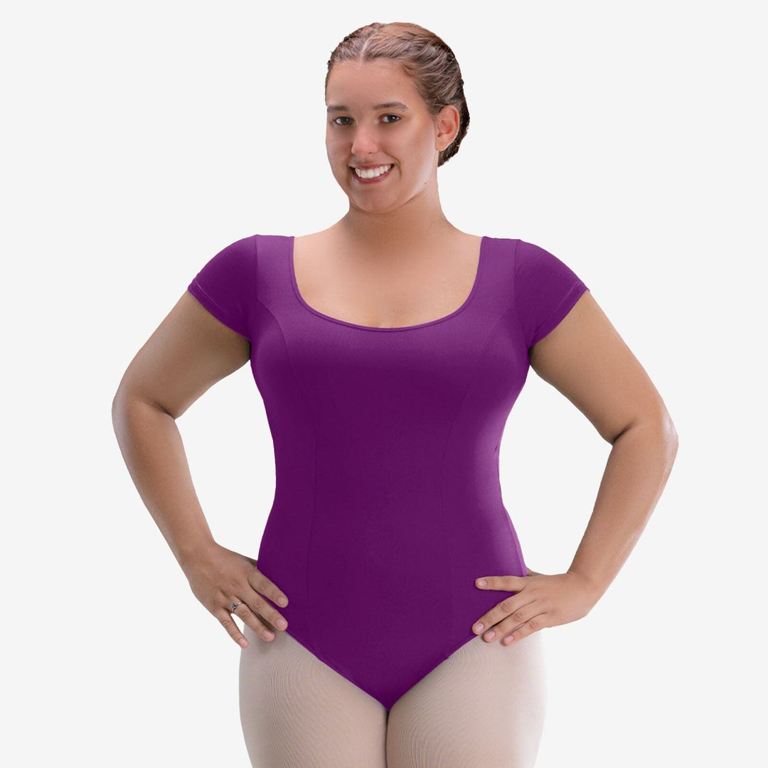 Woman wearing a purple leotard on a white background