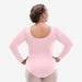 Person wearing a pink long-sleeve leotard on a white background