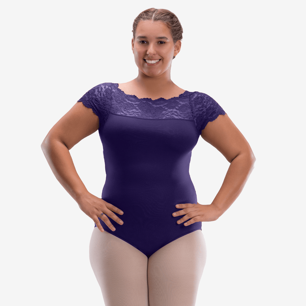 Woman wearing a purple leotard with lace details on a white background