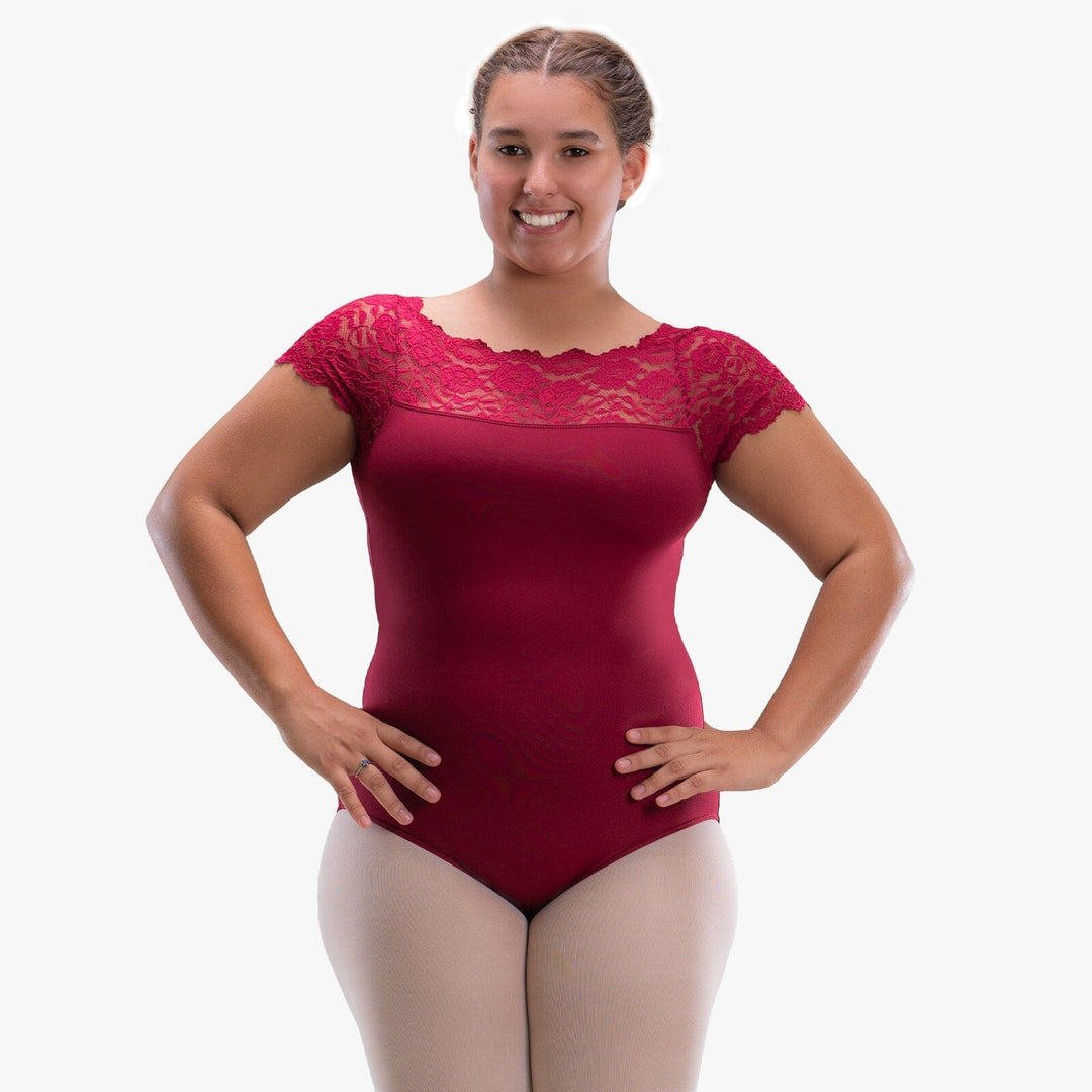 Woman wearing a red leotard with lace details on a white background