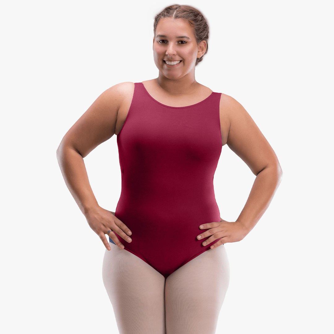 Woman wearing a maroon leotard on a white background