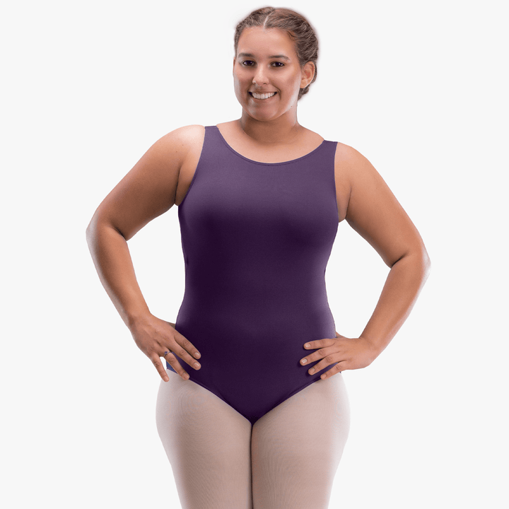 Woman wearing a purple leotard on a white background