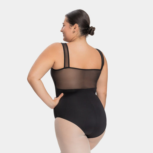 Woman wearing a black bodysuit with sheer mesh panels on a white background