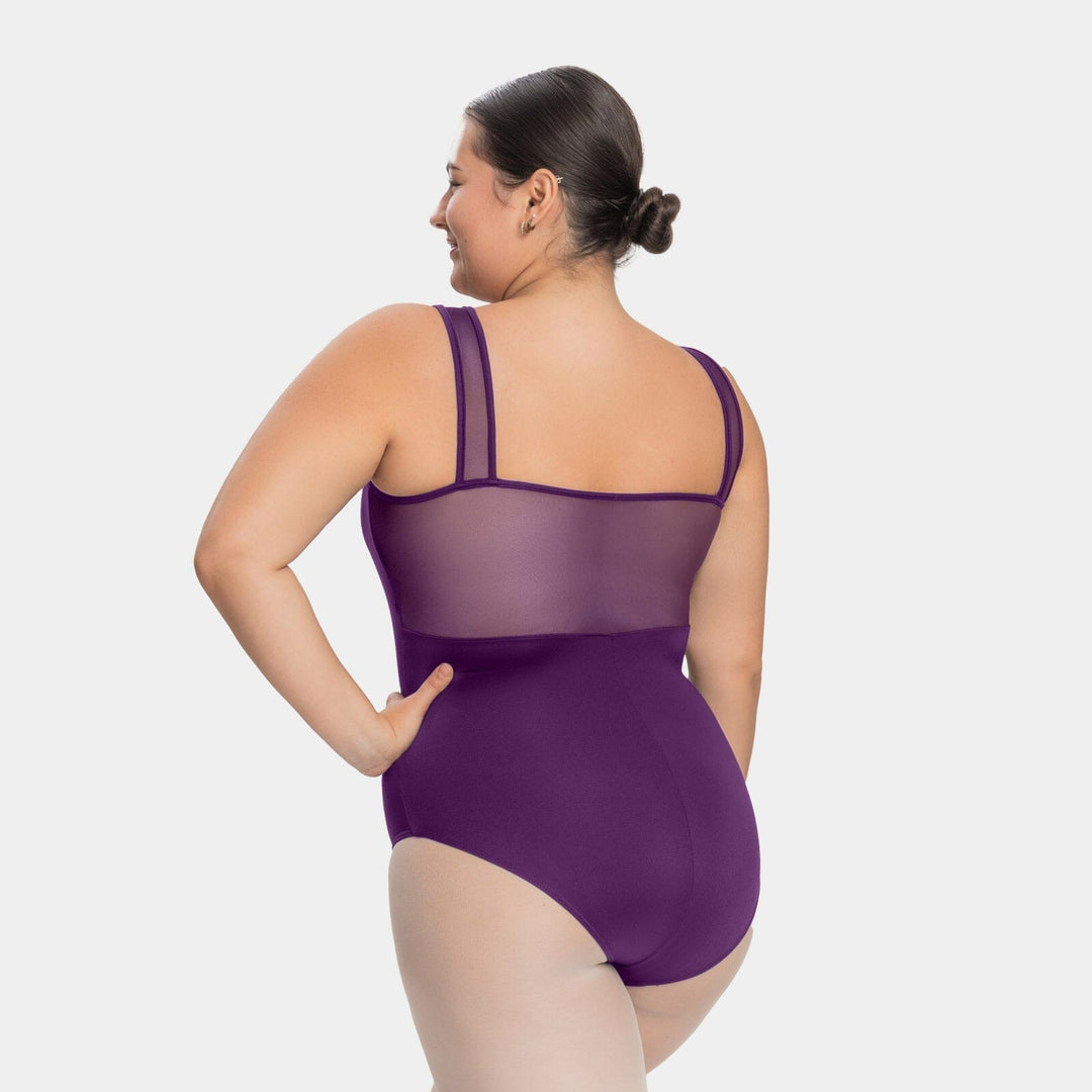 Woman wearing a purple swimsuit with mesh panels on a white background