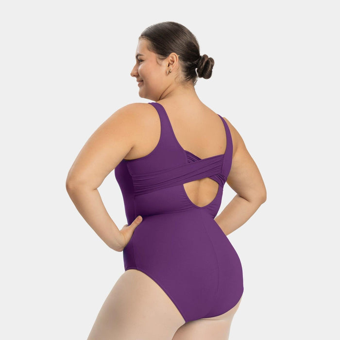 Woman wearing a purple swimsuit with cut-out design on a white background