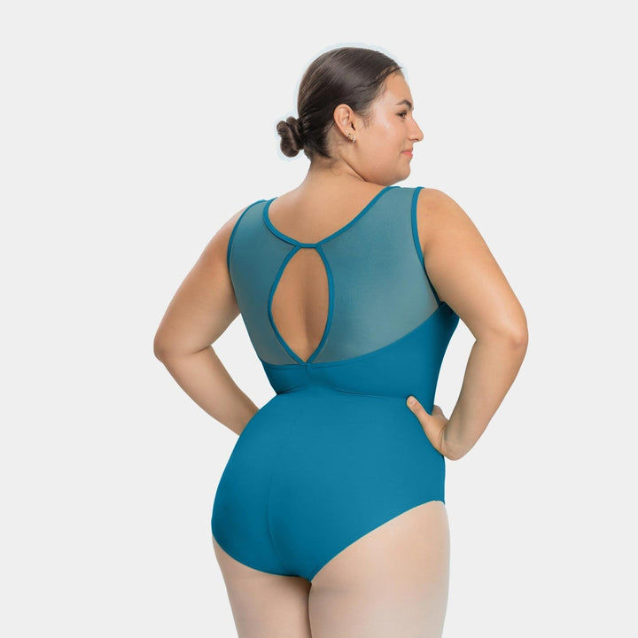 Woman wearing a teal swimsuit with mesh panels on a white background