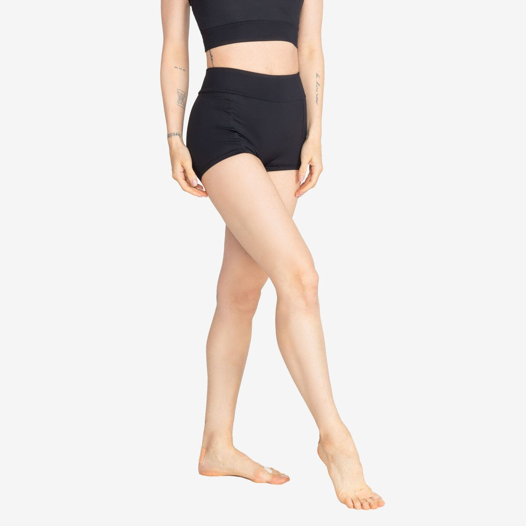 Person wearing black high-waisted shorts on a white background