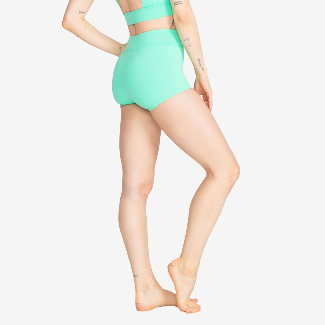 Person wearing a green two-piece swimsuit on a white background