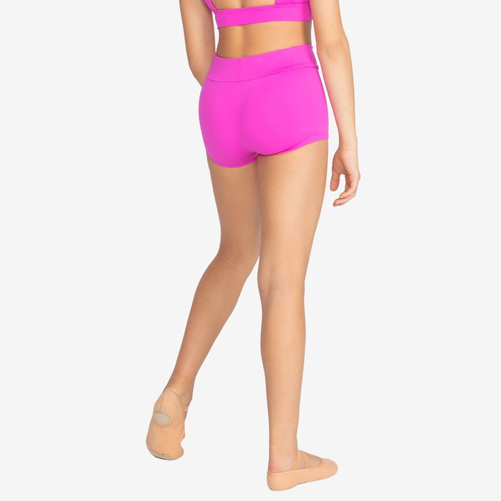 Person wearing bright pink athletic shorts on a white background