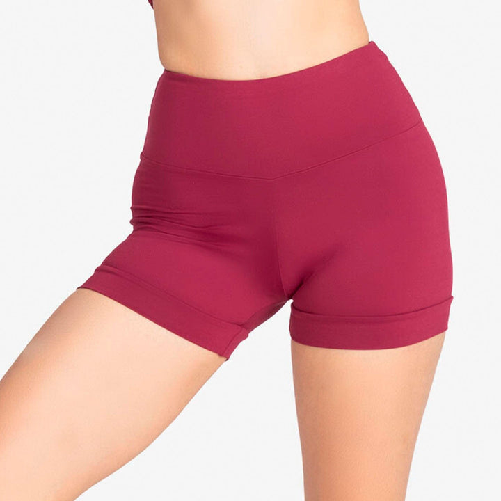 Maroon athletic shorts worn by a person on a light gray background