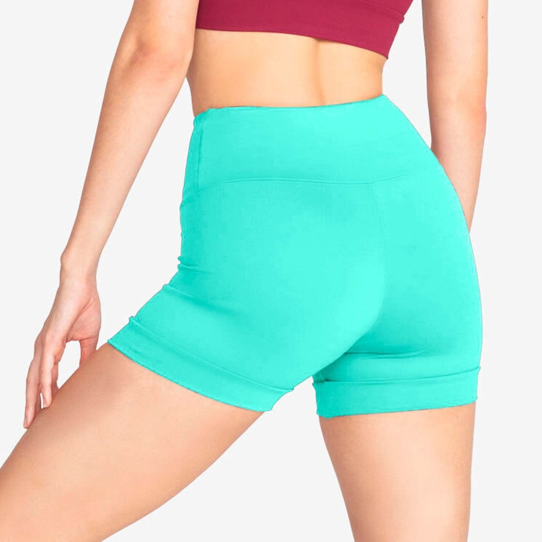 Teal athletic shorts worn by a person on a plain background