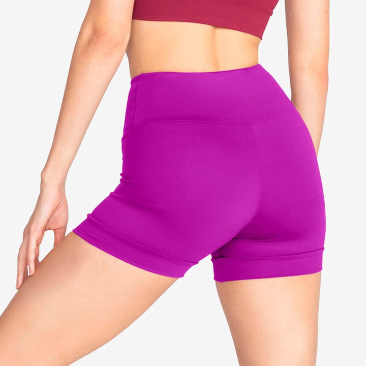 Purple athletic shorts worn by a person on a plain background