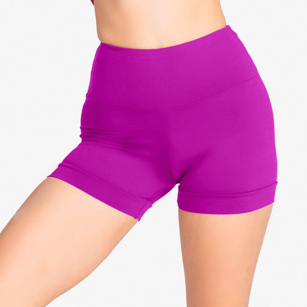Purple athletic shorts worn by a person on a white background