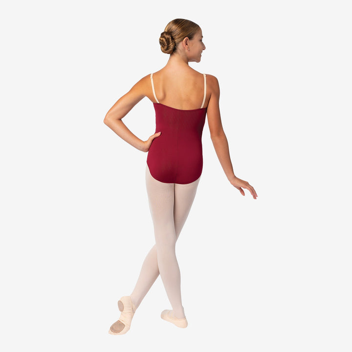Ballet dancer wearing a red leotard on a white background