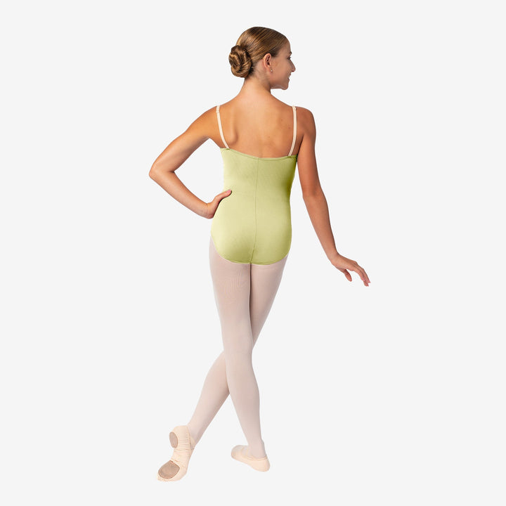 Ballerina in a green leotard and white tights on a white background