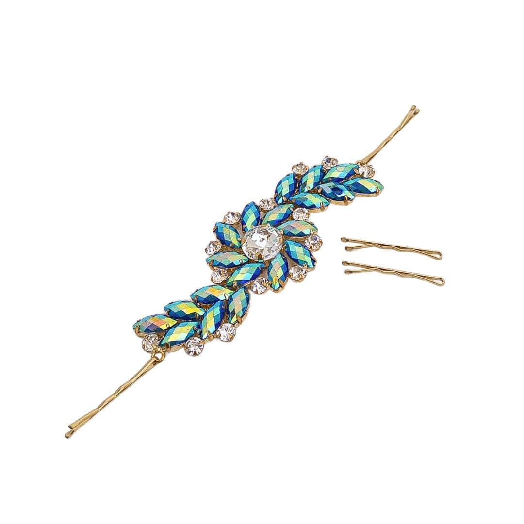 Decorative hairpin with blue and green leaf-like design on a white background