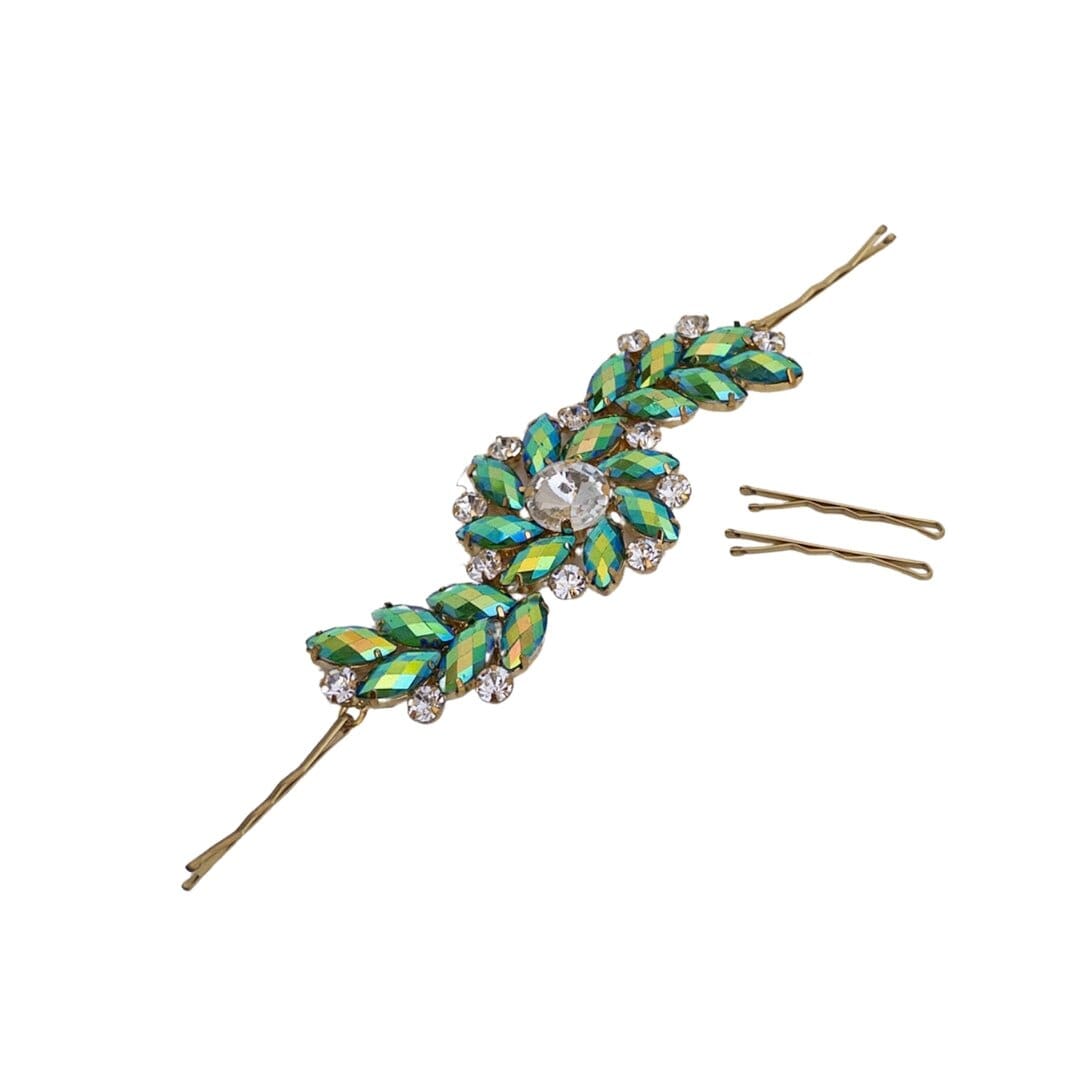 Decorative hairpin with green leaf-like design and gold accents on a white background