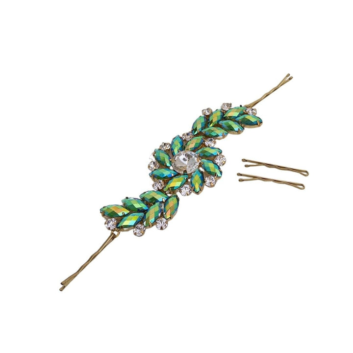 Decorative hairpin with green leaf-like design and gold accents on a white background