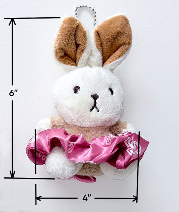 Plush toy rabbit with pink bow, measurements indicated on a white background