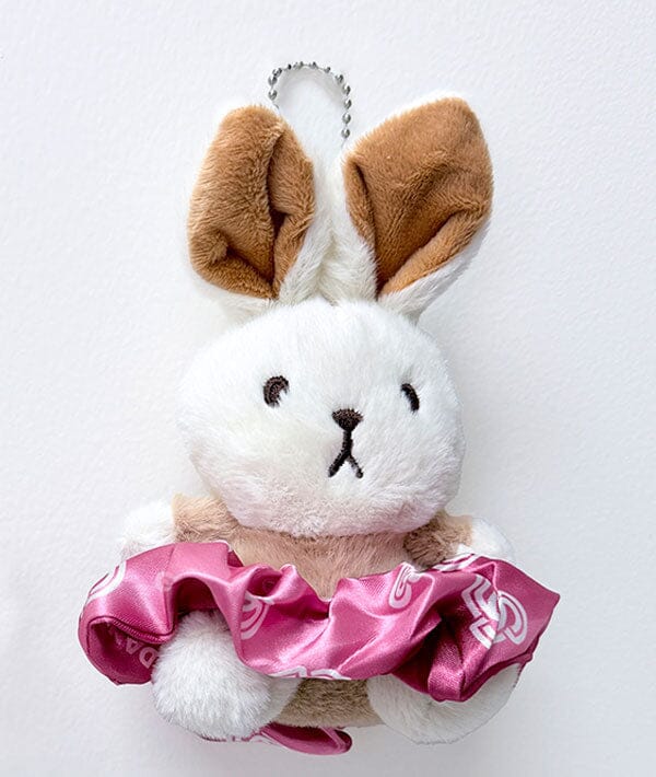 Plush bunny toy with brown ears and pink bow on a white background