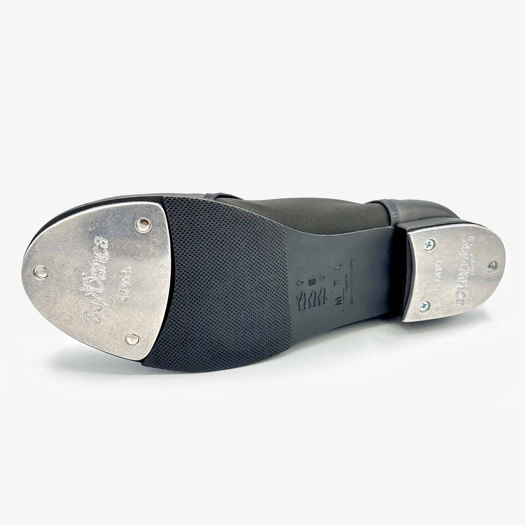 Close-up of tap shoe with metal taps on a white background