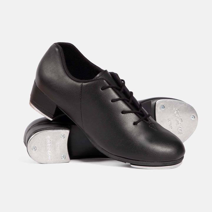 Pair of black tap dance shoes with white soles on a light gray background