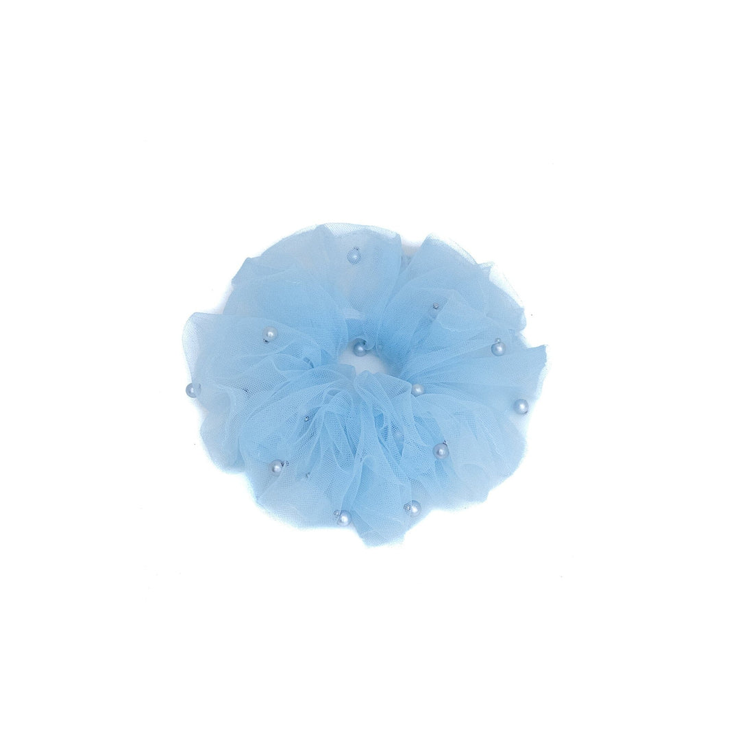 Light blue flower with pearl-like embellishments on a white background