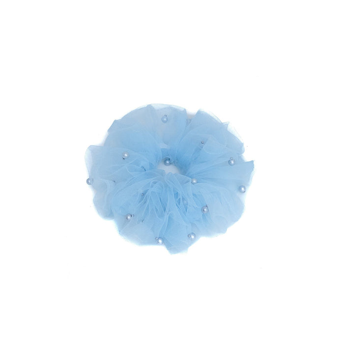 Light blue flower with pearl-like embellishments on a white background