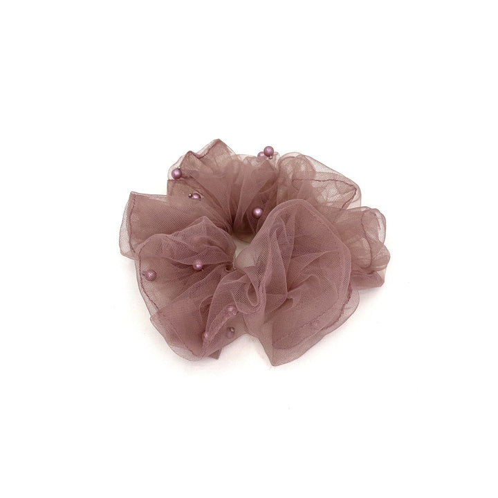 Translucent brown scrunchie with small pearls on a white background