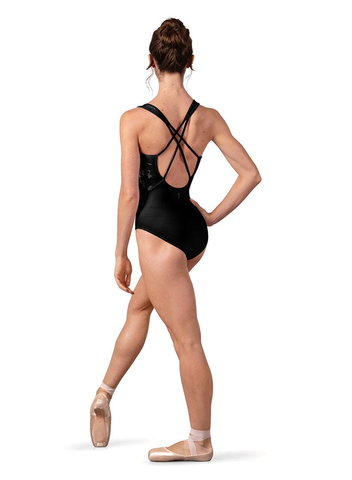 Ballerina in a black leotard with open back on a white background