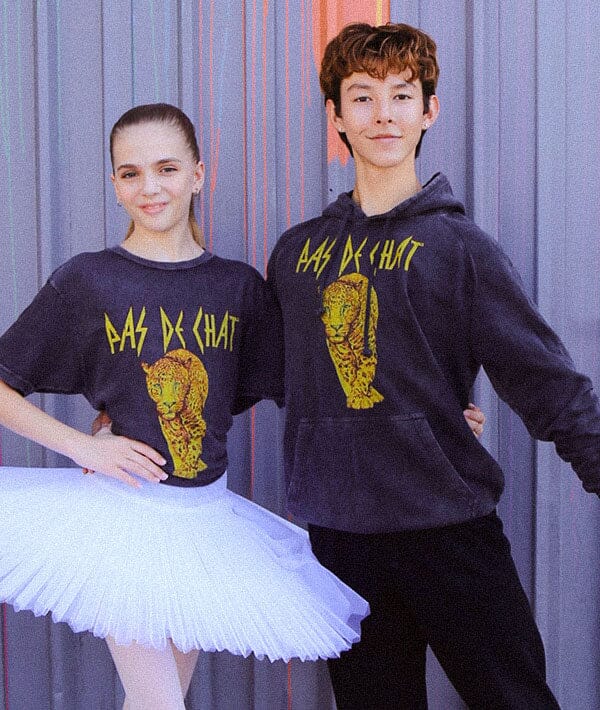 A male and a female dancer with a tutu wearing the hoodie