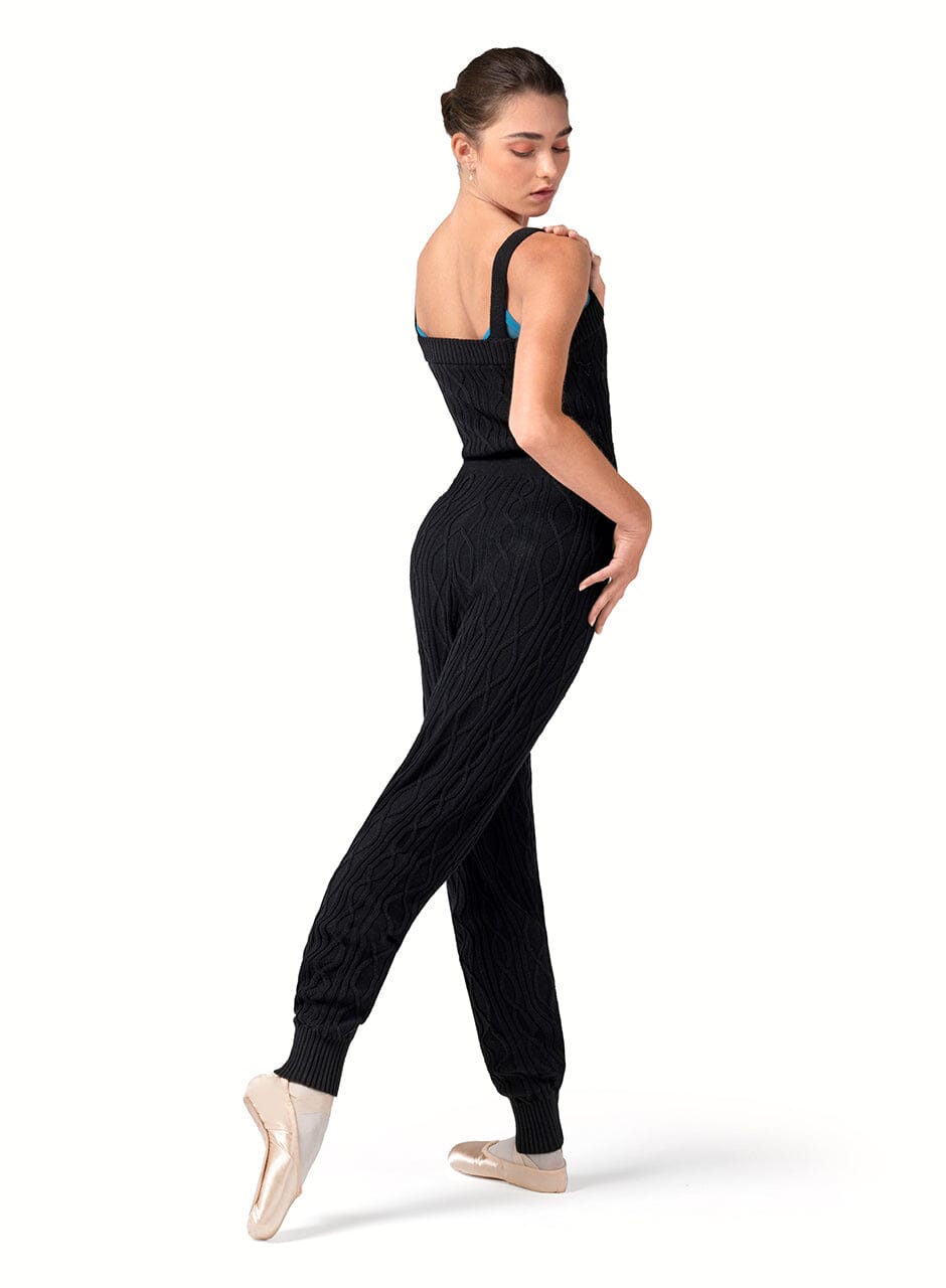 Dancer in a black ribbed jumpsuit on a white background