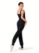 Dancer in a black ribbed jumpsuit on a white background