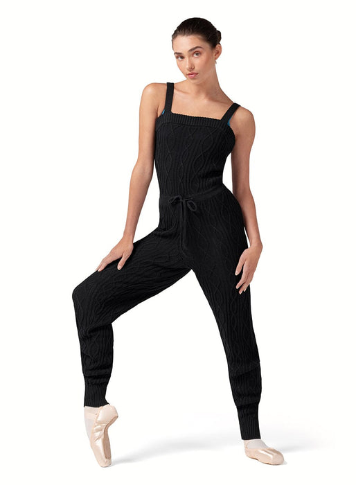 Woman wearing a black ribbed jumpsuit on a white background